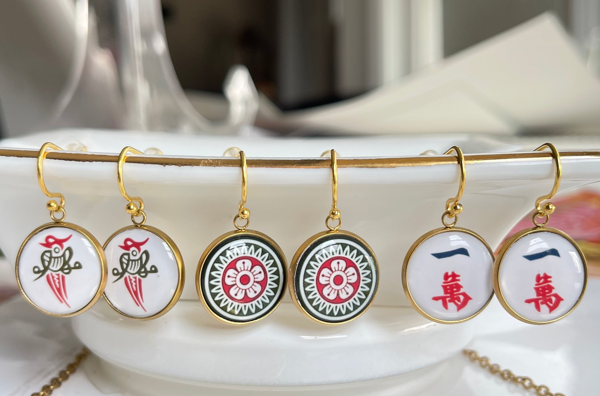 gold mahjong earrings of crack dot and bird bam